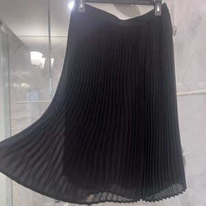 NWOT Black Pleated Skirt with elastic waist. MIDI length.